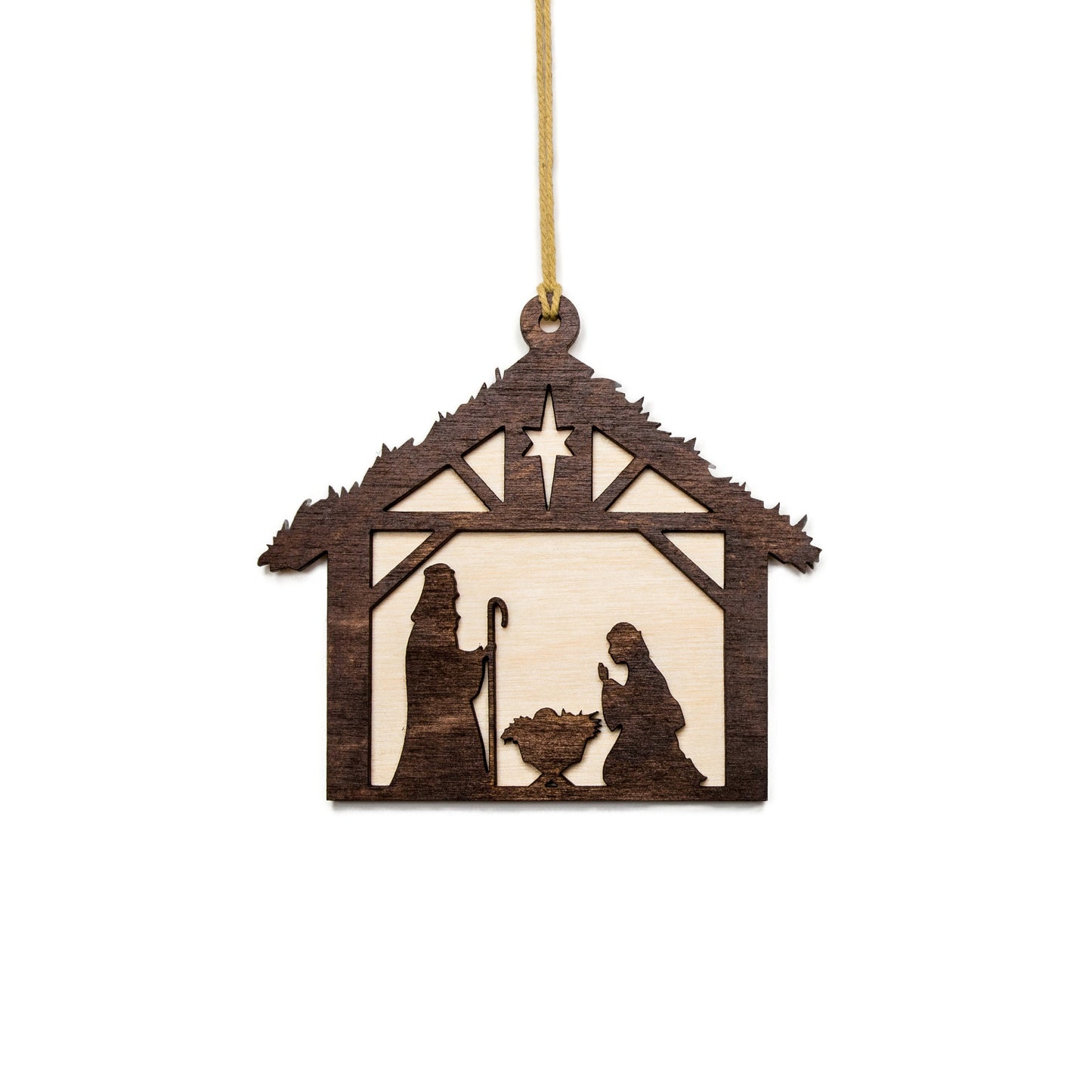 a wooden ornament depicting a nativity scene